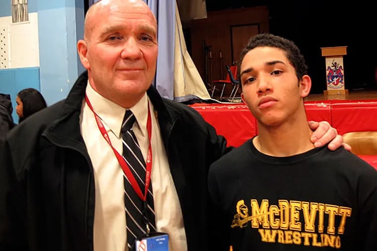 Bishop McDevitt wrestling coach Bill Hunter (left) with 120-pounder
Joshua Velez-Arce. (Rick O'Brien/Staff)