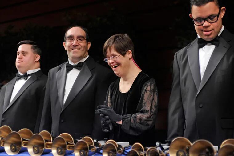 Patrick Gilronan (from left), Marc Deschodt, Meg Garner, and Christian White of the Joybells, a handbell choir of adults with Down syndrome, plays with the chamber orchestra at the Kimmel. TOM GRALISH / Staff Photographer