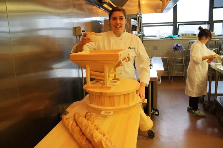 Ally Zeitz, manager of Drexel’s Food Lab, with the school’s grain mill.
