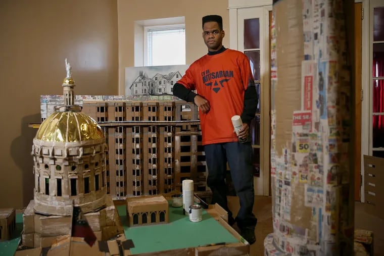 Kambel Smith with some of his architectural models in progress at his home in Philadelphia's Germantown section.
