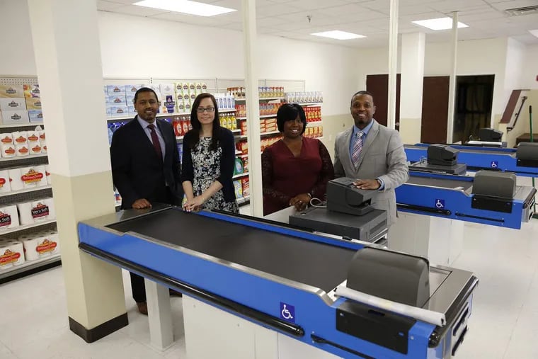 Enon Baptist Tabernacle Church will house a job-training program to teach people who have been in prison how to become supermarket cashiers. Graduates will get jobs at Brown’s SuperStores, a chain of 13 ShopRite and Fresh Grocer stores. Left to right: Atif Bostic, head of UpLift Solutions, the nonprofit developing the program, social worker Lauren Ruday, chief instructor Monique Oakman, and Barry Johnson, program director, line up in the classroom at Enon.  DAVID MAIALETTI / Staff Photographer