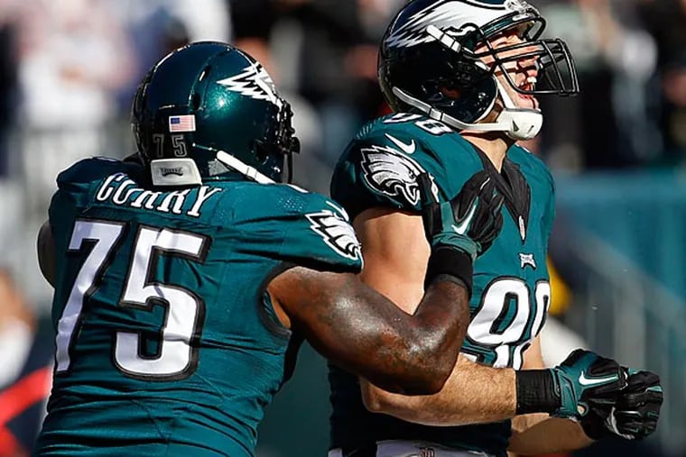 Connor Barwin celebrates a first-quarter sack with teammate Vinny Curry against the Tennessee Titans. (Yong Kim/Staff Photographer)