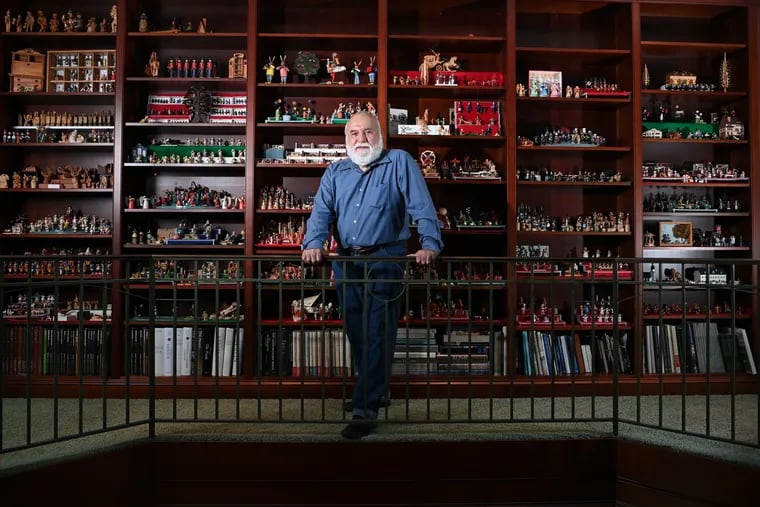 Jorge Flores in front of a portion of his miniature collection at his home in Potomac, Md.