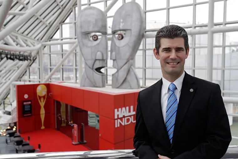Gregory Harris poses in front of an exhibit after being named president and CEO of the Rock and Roll Hall of Fame and Museum in Cleveland Monday, Dec. 3, 2012. Harris, The rock hall's vice president of development since 2008, succeeds Terry Stewart, who has lead the Rock Hall since 1999. (AP Photo/Mark Duncan)