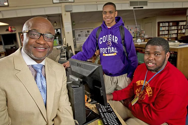 Martin Luther King principal William Wade with Emmanuel Clark (center) and Frank Darden, whose football team went from 1-10 to the Public League title after merger with Germantown High. (Alejandro A. Alvarez/Staff)