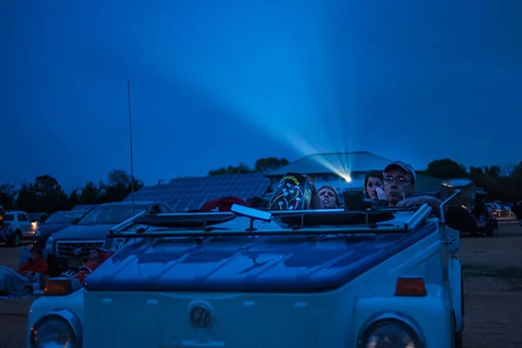 Bill Phifer and his family enjoy a movie from their convertible at the Delsea Drive-In, in Vineland, New Jersey on Friday, May 9, 2014. The theater shows two double features on separate screens starting just past sundown.