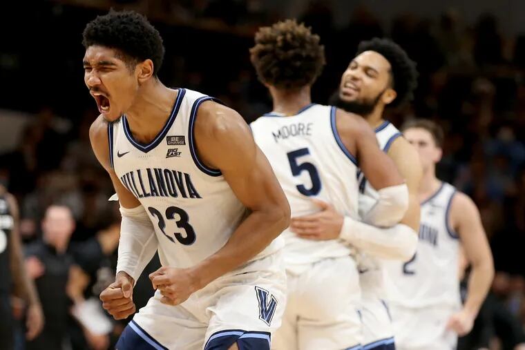 Jermaine Samuels, left, of Villanova celebrates after Justin Moore basket  gave Villanova a ten point lead over Xavier with 91 seconds to go in the game on Dec. 21, 2021 at the Finneran Pavilion at Villanova University.  Caleb Daniels, right, congratulates Moore in the background.