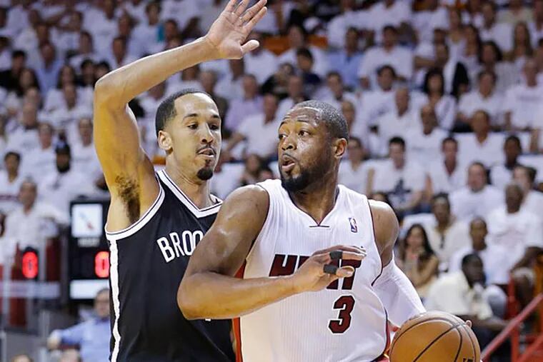 Miami Heat guard Dwyane Wade (3) drives gainst Brooklyn Nets guard Shaun Livingston during the first half of Game 2 of an Eastern Conference semifinal NBA playoff basketball game, Thursday, May 8, 2014 in Miami. (AP Photo/Wilfredo Lee)