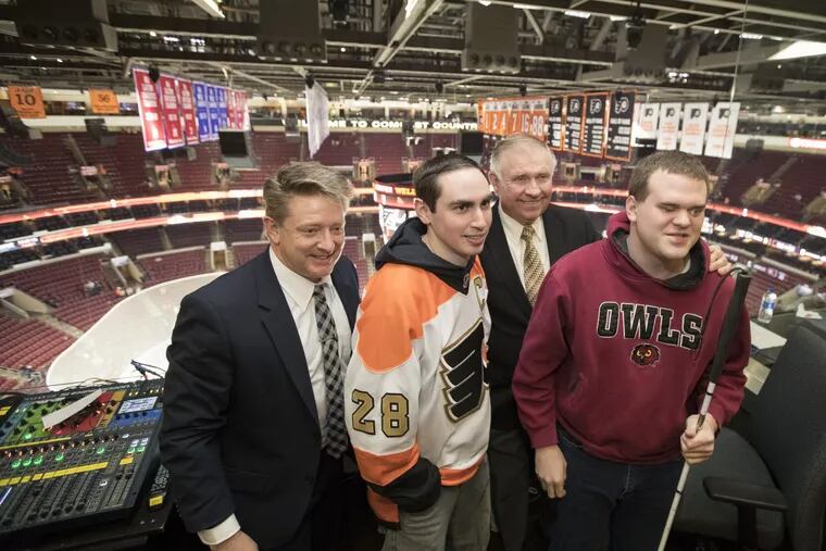 Philadelphia Flyers froadcaster Tim Saunders, left, and partner Steve Coates, 3rd from left, hosted Temple graduates Sam Fryman, 2nd from left, and Matt Wallace, who is blind, at Wells Fargo Center on March 15, 2018. CHARLES FOX / Staff Photographer