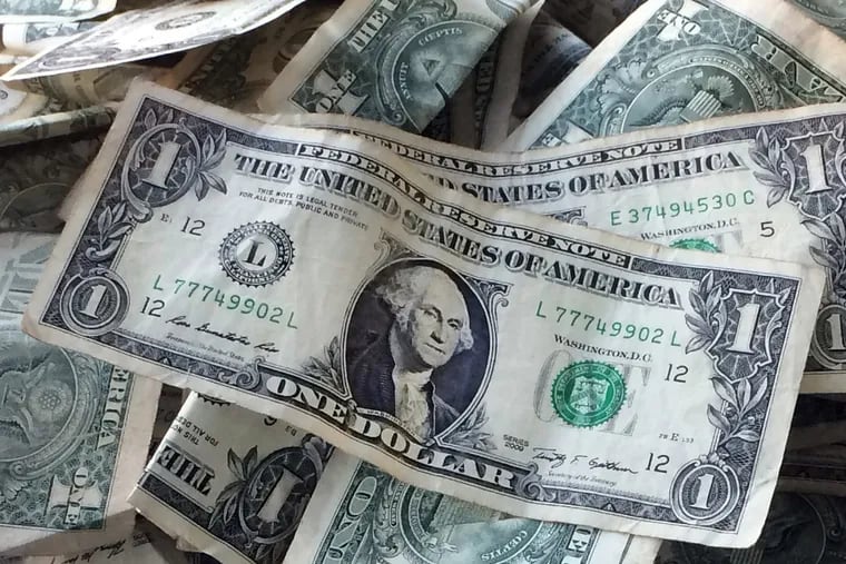 FILE – This Oct. 24, 2016, file photo shows dollar bills in New York. (AP Photo/Mark Lennihan, File)