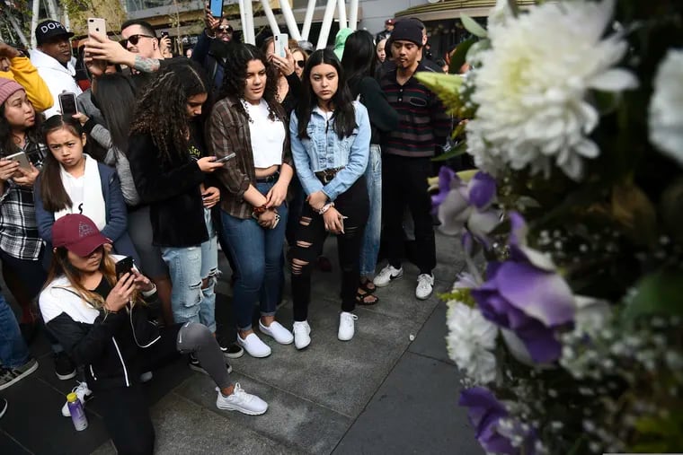 People gathered at a makeshift memorial honoring former NBA player Kobe Bryant outside of the Staples Center prior in Los Angeles.