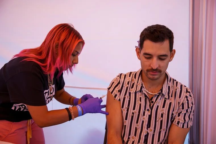 Letty Arreola, 27, gives Cory Hawkins, 35, a monkeypox vaccine at the Silver Room Block Party in Chicago on July 17, 2022. (Armando L. Sanchez/Chicago Tribune/TNS)
