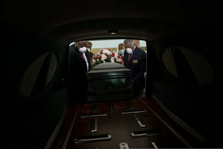 Mortician Cordarial O. Holloway, foreground left, funeral director Robert L. Albritten, foreground right, and funeral attendants Eddie Keith, background left, and Ronald Costello place a casket into a hearse on Saturday, April 18, 2020, in Dawson, Ga. Across the county, the latest Associated Press analysis of available state and local data shows that nearly one-third of those who have died from COVID-19 are African American, with black people representing about 14% of the population in the areas covered.
