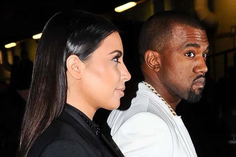 Kim Kardashian and Kanye West arrive at Givenchy's Ready to Wear's Fall-Winter 2013-2014 fashion collection presented Sunday, March 3, 2013 in Paris. (AP Photo/Zacharie Scheurer)