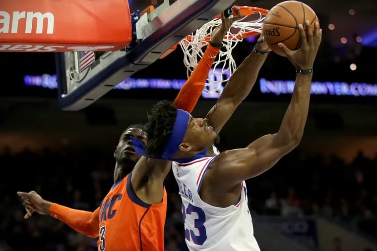 The Sixers' Jimmy Butler (23), here attempting a layup around the Oklahoma City Thunder's Nerlens Noel (3), Jan. 19, will miss his third consecutive game with a sprained right wrist.