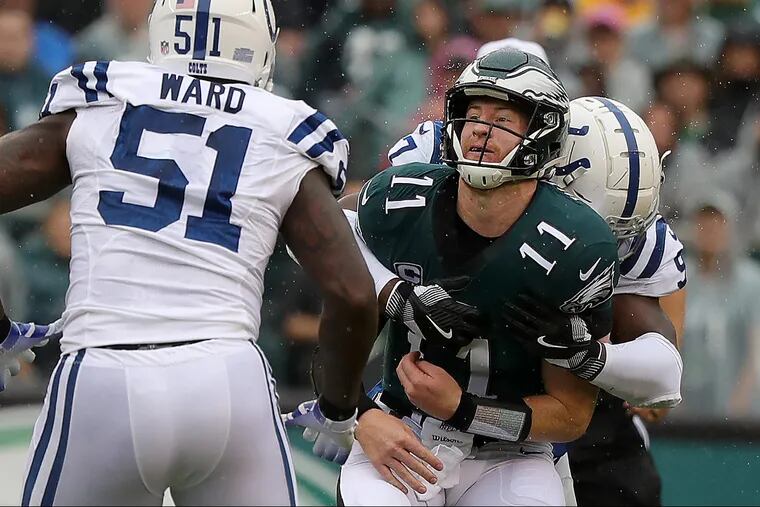 Carson Wentz, here getting hit by the Colts' Al-Quadin Muhammad after releasing a pass, will make his second start of the season Sunday in Nashville.