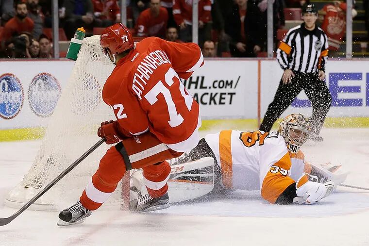 Detroit Red Wings center Andreas Athanasiou (72) scores on Philadelphia Flyers goalie Steve Mason (35) during the second period of an NHL hockey game, Wednesday, April 6, 2016, in Detroit.