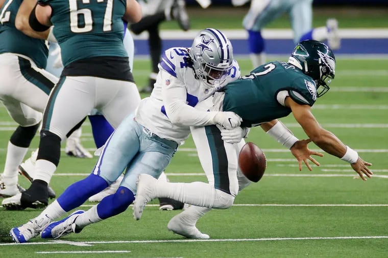 Dallas Cowboys defensive end Randy Gregory (94) sacks Jaylon Hurts and forces a fumble, this one recovered by the Eagles' Jordan Mailata.