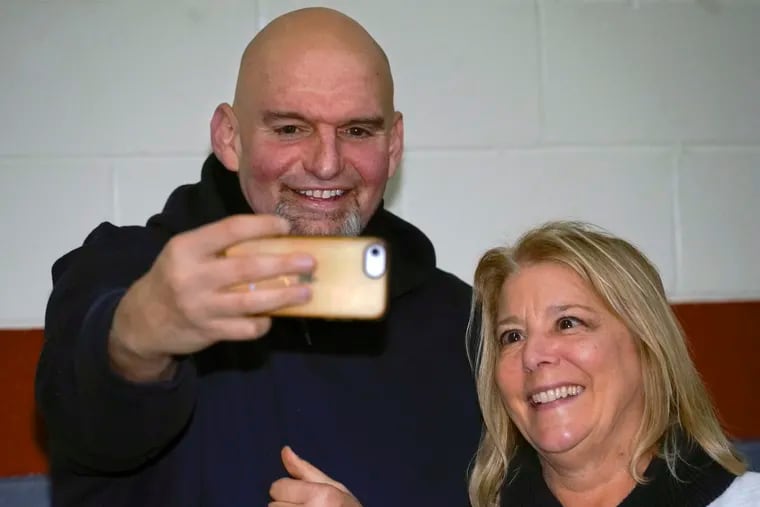 Pennsylvania Lt. Gov. John Fetterman takes a selfie with Barbra Speer during a February campaign stop at the Mechanistic Brewery in Clarion, Pa. New attacks by Fetterman's Democratic rivals in the Senate race will test the durability of his long-held lead ahead of the May 17 primary.