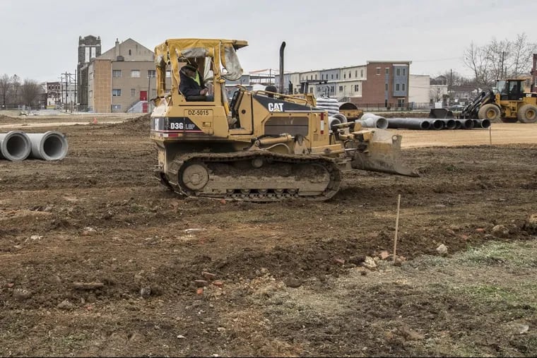 A bulldozer performing work in Sharswood, a public housing building site in North Philadelphia.