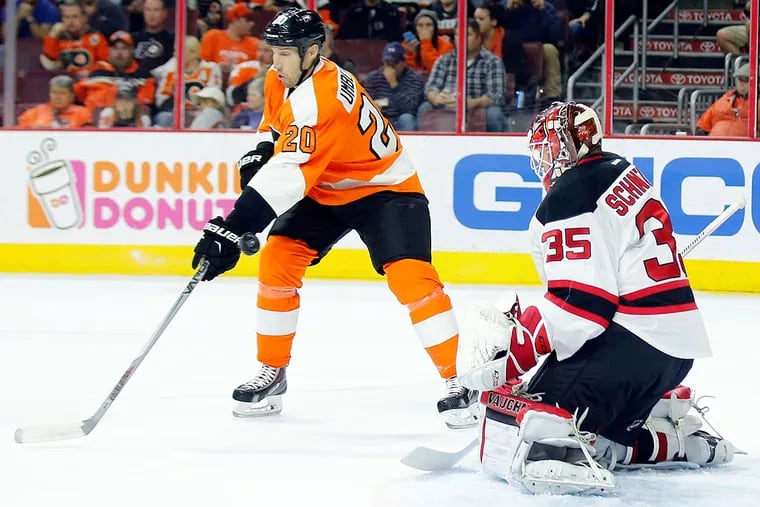 Flyers' R.J. Umberger tries to defects the puck past New Jersey Devils' goalie Cory Schneider in the first-period on Thursday, October 29, 2015 in Philadelphia.