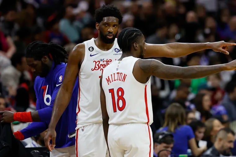 Sixers center Joel Embiid and teammate guard Shake Milton during a break against the Charlotte Hornets on Sunday.