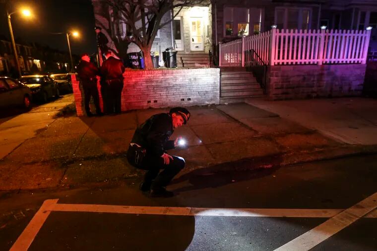 Philadelphia police Chief Inspector Scott Small looks for evidence as they investigate a shooting at 4320 Cotton Avenue Monday evening, February 17, 2020.