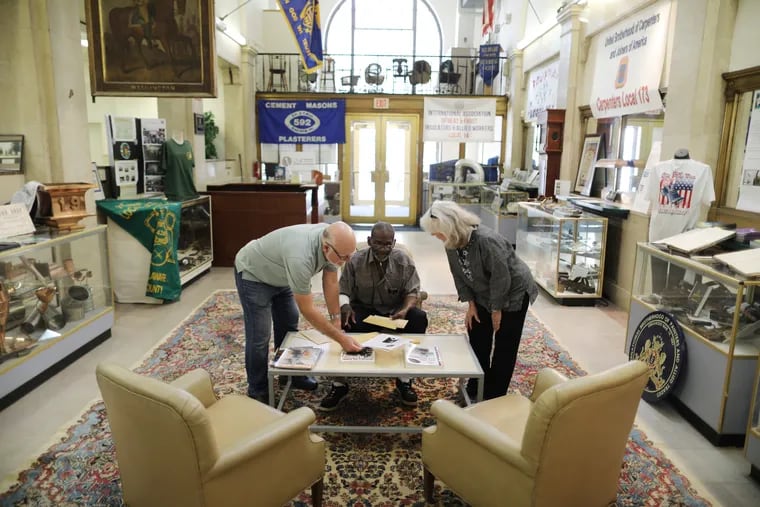 Patrick Janney and Margaret Johnson help Chester resident Darnley Belgrave Jr., with research at the Delaware County Historical Society. The society's leadership recently relocated to its location in downtown Chester, hoping to contribute to a wave of revitalization in the city.