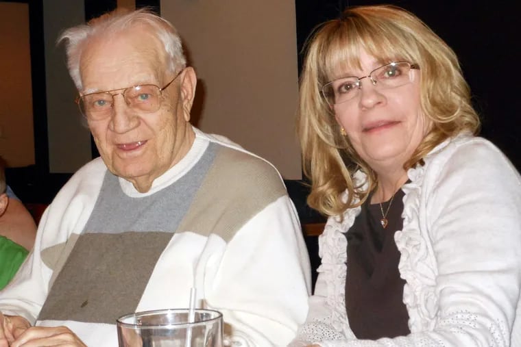 Pam Tripaldi with her father, John Schatz, on his 86th birthday in 2014. She is advocating that patients wear a special wristband for dementia.