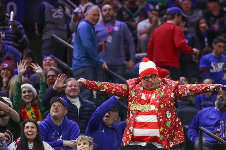 A Sixers fan dressed in Christmas attire dances during a game against the Milwaukee Bucks at the Wells Fargo Center in South Philadelphia on Wednesday, Dec. 25, 2019. Sixers won, 121-109.