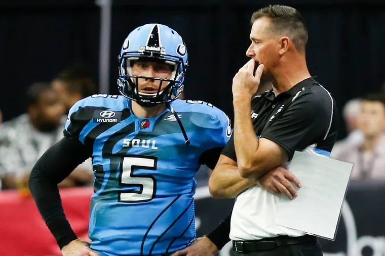 Soul quarterback Dan Raudabaugh stands on the sidelines with head coach Clint Dolezel during a May game against the Empire.
