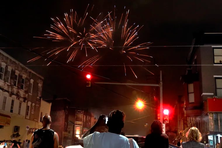 Residents watch the Art Museum fireworks explode over their neighborhood around 29th Street and Girard Avenue in 2018.