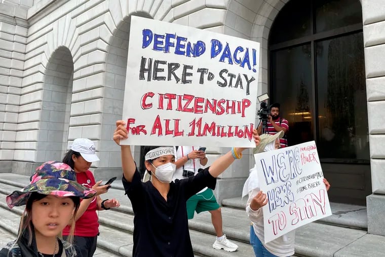 Demonstrators hold up signs outside the 5th U.S. Circuit Court of Appeals building in New Orleans on July 6. A panel of 5th Circuit judges heard arguments on an Obama-era program that prevents the deportation of thousands of immigrants brought into the United States as children. A federal judge in Texas last year declared the Deferred Action for Childhood Arrivals program illegal — although he agreed to leave the program intact for those already benefiting from it while his order is appeal. (AP Photo/Kevin McGill)