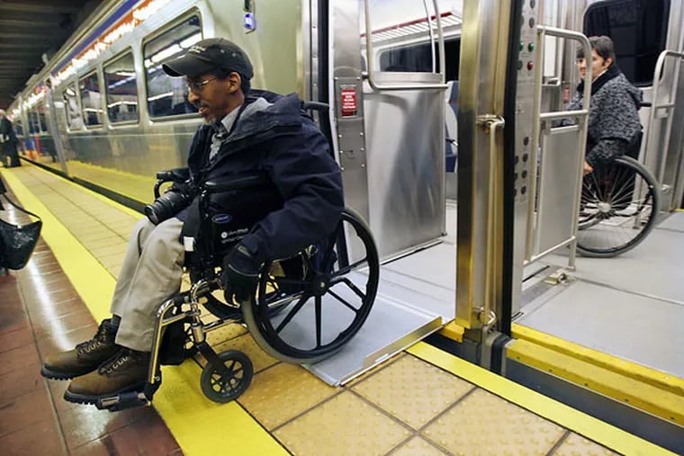 Thaddeus Robinson of Philadelphia and Judy Buddendorf of Delaware County navigate their way through the new railcar. They are members of the SEPTA advisory committee that helped address issues affecting disabled people riding SEPTA trains.