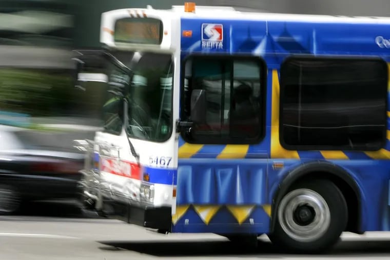 A SEPTA bus passes City Hall near Market Street.