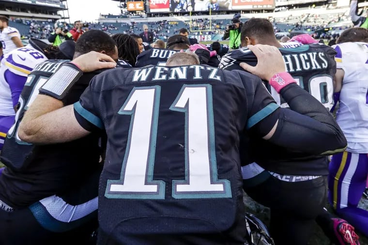 Philadelphia Eagles quarterback Carson Wentz (11) prays with fellow players following the NFL football game against the Minnesota Vikings on Oct. 23, 2016.
