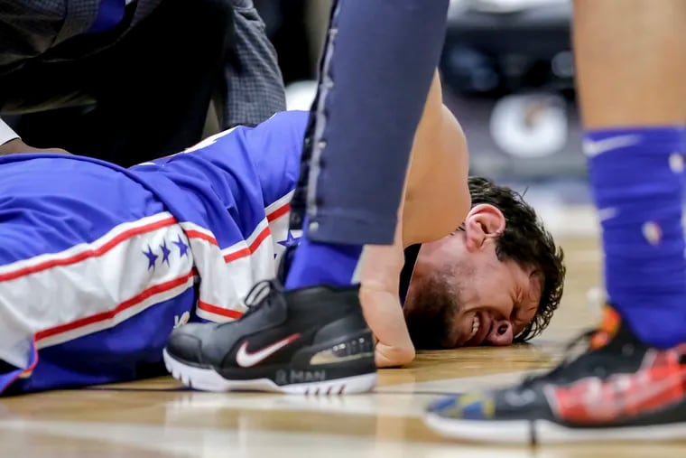 Sixers center Boban Marjanovic (51) winces in pain after being injured late in Monday's 111-110 victory over the New Orleans Pelicans.