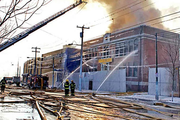 The Global Leadership Academy at 5151 Warren St. in West Philadelphia may not resume classes for the rest of the week after Sunday's fire. (Ed Hille/Staff)
