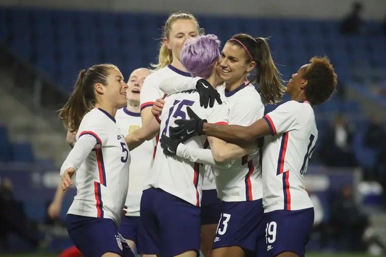 Megan Rapinoe (15) is congratulated by teammates after scoring the opening goal.