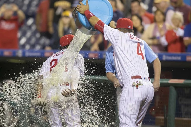 Roman Quinn gets a Gatorade bath courtesy of teammate Andres Blanco after the Phillies beat the Pirates 6-2 in the series opener . ED HILLE / Staff Photographer.