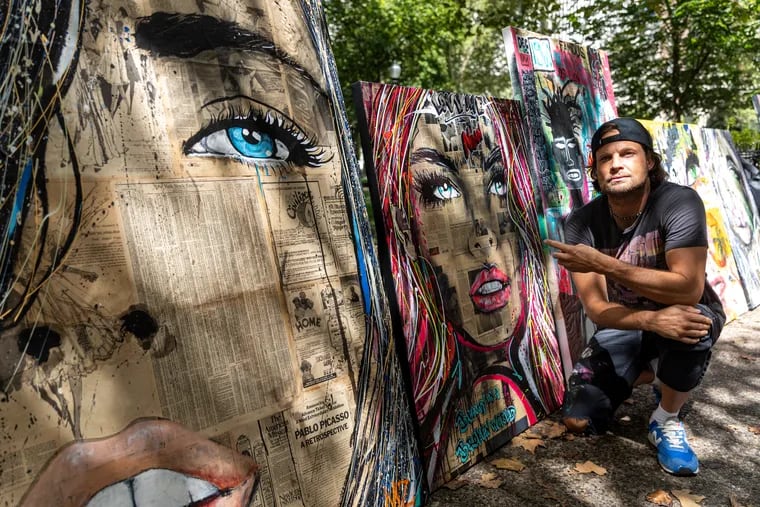 Michael Zallie, 45, of Center City, Pa., Mixed Medium artist, displays his work of art at Rittenhouse Square during a peaceful protest showing support to local artists and those who’ve had their work confiscated in Philadelphia, Pa., on Saturday, Aug., 26, 2023.