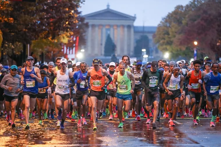 The elite runners take off at the starting line of the Philadelphia Marathon on the Ben Franklin Parkway on a wet and cold Sunday morning.