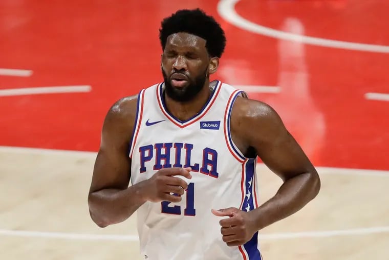 Sixers center Joel Embiid leaves the court grimacing during the third quarter against the Atlanta Hawks in Game 3 of the Eastern Conference semifinals on Friday, June 11, 2021 in Atlanta.