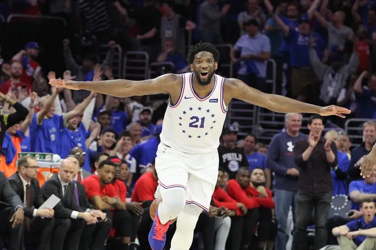 Joel Embiid of the Sixers celebrates as he runs down court after a windmill dunk against the Raptors during the 4th quarter of their NBA playoff game at the Wells Fargo Center on May 2, 2019.