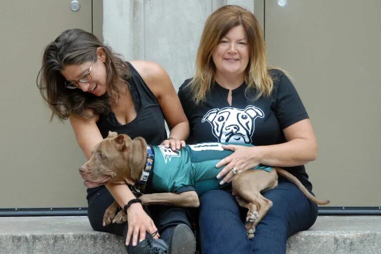 Stephanie Sena (left) and Michele Schaffer-Stevens, with StevensÕ dog Aladdin, are partnering to open a pet-friendly homeless shelter in Philadelphia.