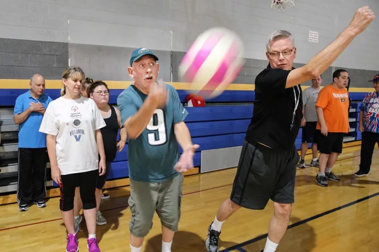 Fran Brett (right), recently named Special Olympics Pennsylvania coach of the year, helps Stephen Fields, 71, with his serve during volleyball practice at  the Conshohocken Community Center at the Fellowship House.