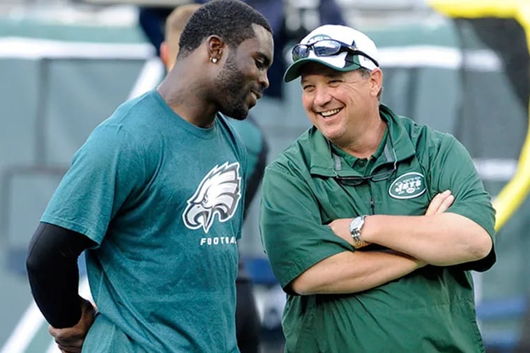 Michael Vick (left) could be reunited with former Eagles offensive coordinator Marty Mornhinweg (right) if he joins the New York Jets.