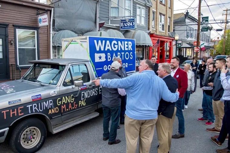 New Cumberland mayor Mayor Doug Morrow (back to camera) shows candidate for the Republican nomination for governor Scott Wagner the “Original Trump Truck” used during the 2016 presidential election, as Wagner meets and greets supporters at Fratelli’s Towne Tavern in New Cumberland April 29, 2018.