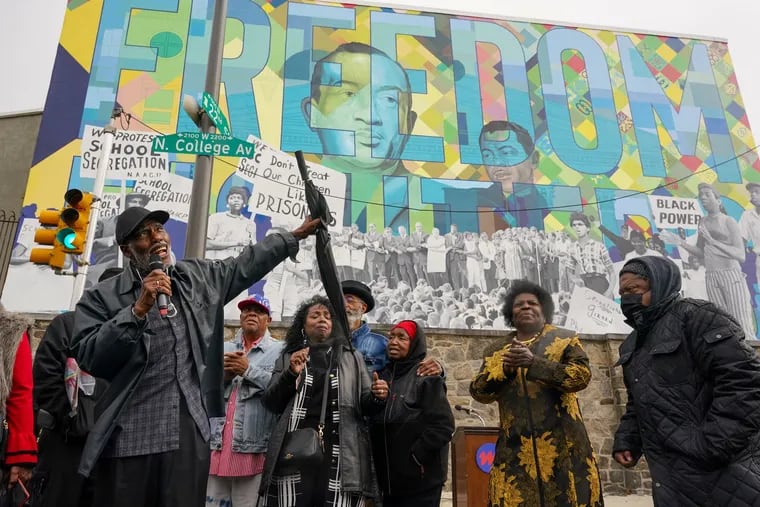 Kenneth “Freedom Smitty” Salaam sings with members of the original Philadelphia Freedom Fighters at the Cecil B. Moore Freedom Fighters mural at Girard College in Philadelphia on Saturday. The mural was painted to honor the Philadelphia Freedom Fighters and Cecil B. Moore for their efforts to desegregate Girard College.