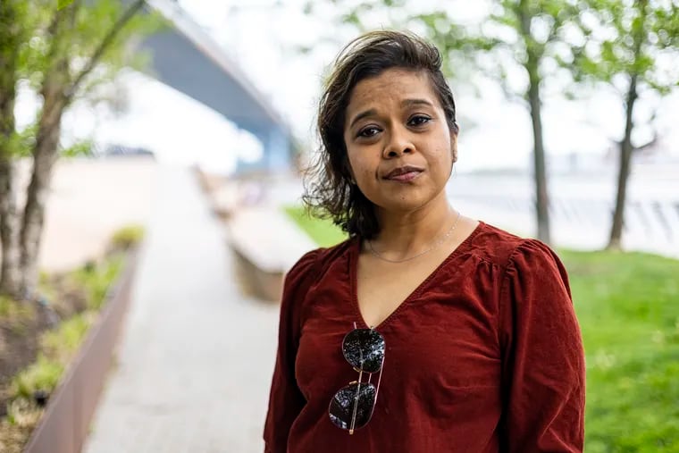 Shreya Datta, 37, of Old City, Pa., poses for a portrait at the Race Street Pier in Philadelphia, Pa., on Saturday, April 22, 2023. Datta was scammed for about $450,000 from a guy she dated for 3-months on hinge.